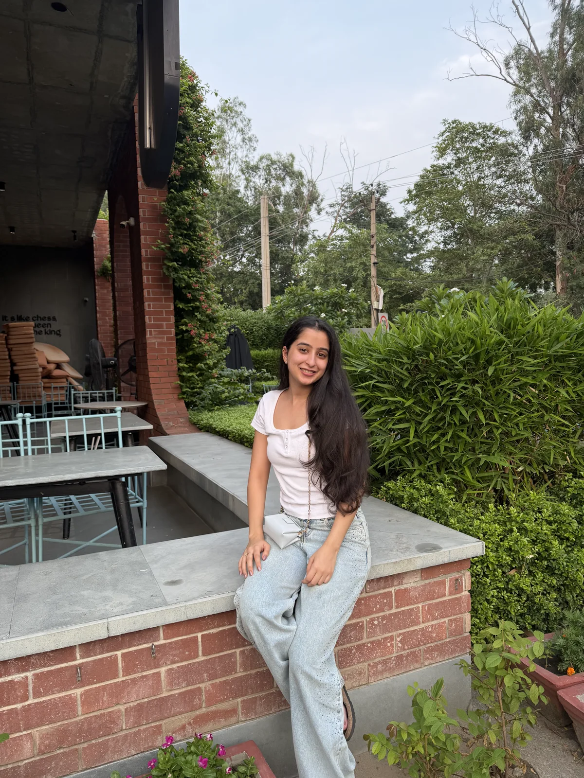 Himanshi Sahni sitting outdoors beside greenery